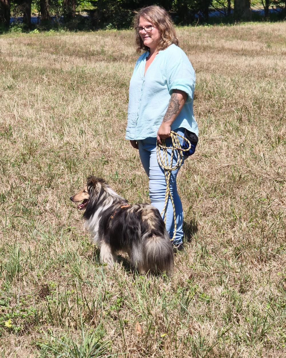 Longe tenue en boucles souples dans la main, sans tension jusqu'au harnais du chien